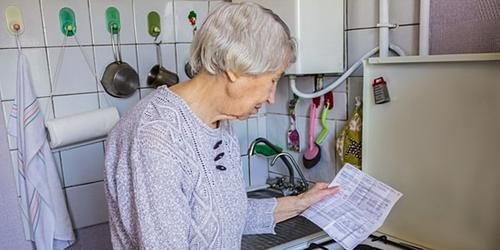 Older lady examining  gas/electric bill with concern